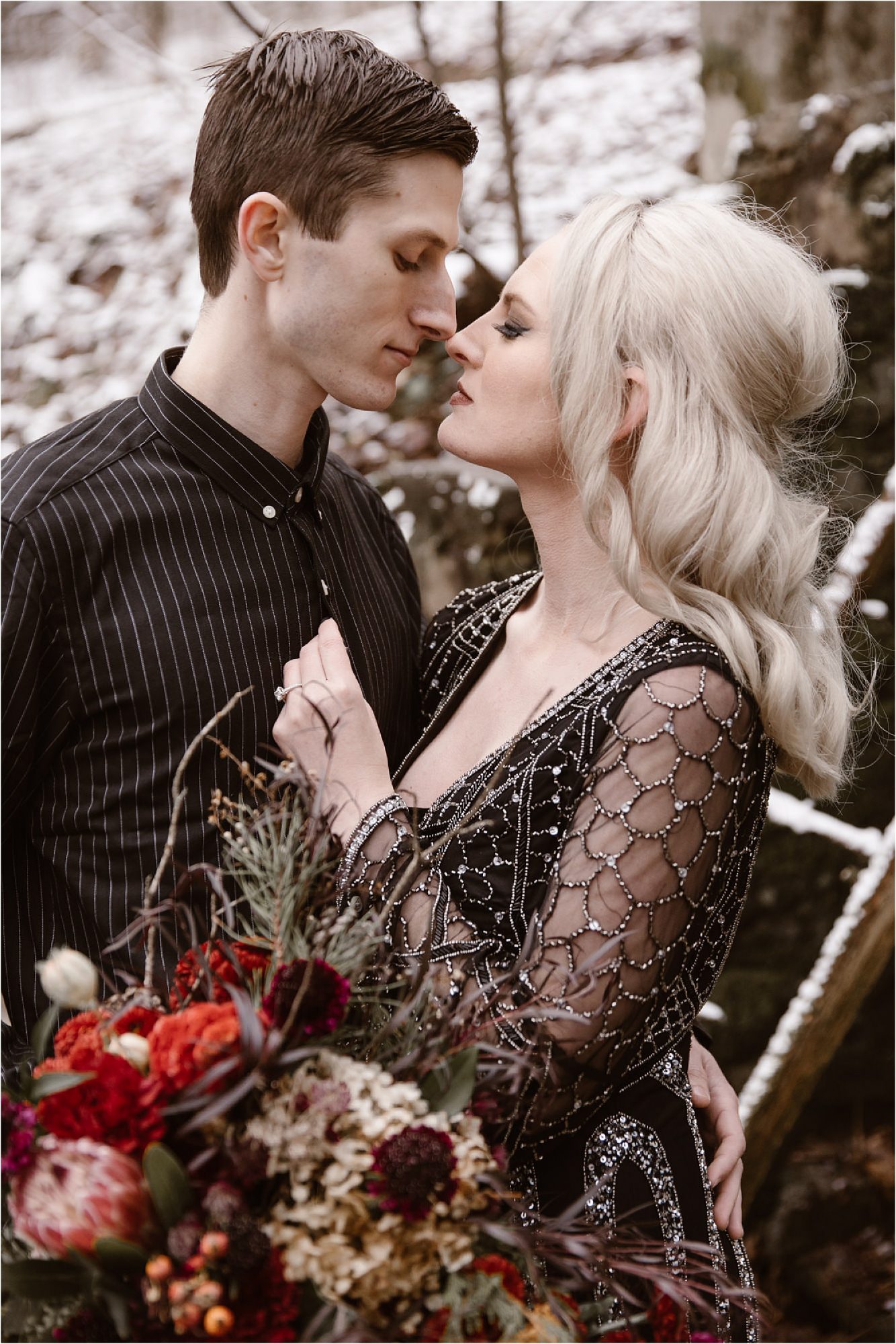 man and woman kissing while wearing black shirt and black wedding dress