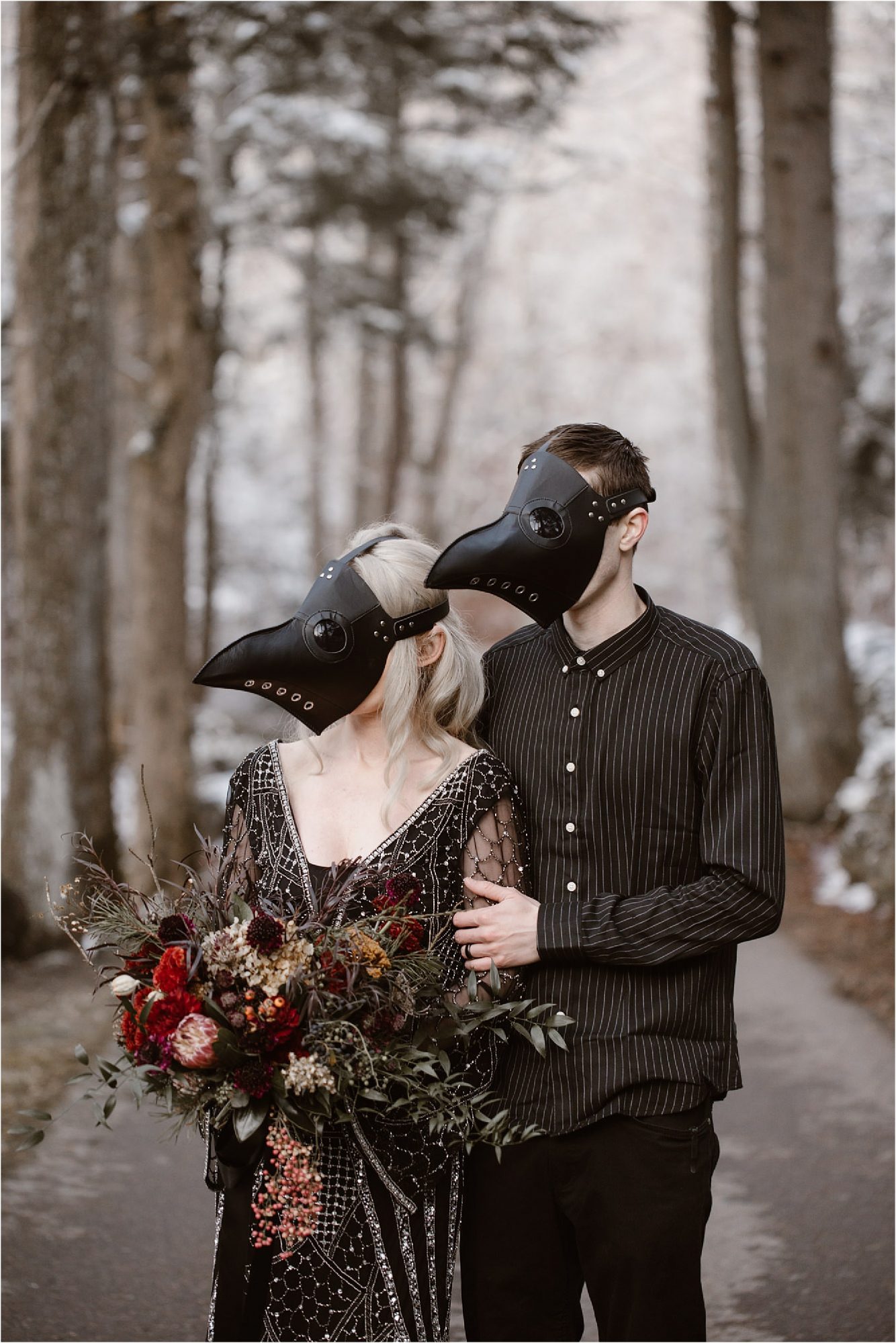 bride and groom in black plague masks