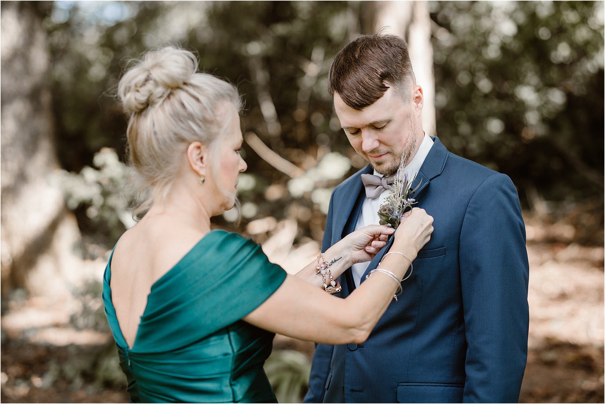 mother of the groom pinning boutonniere