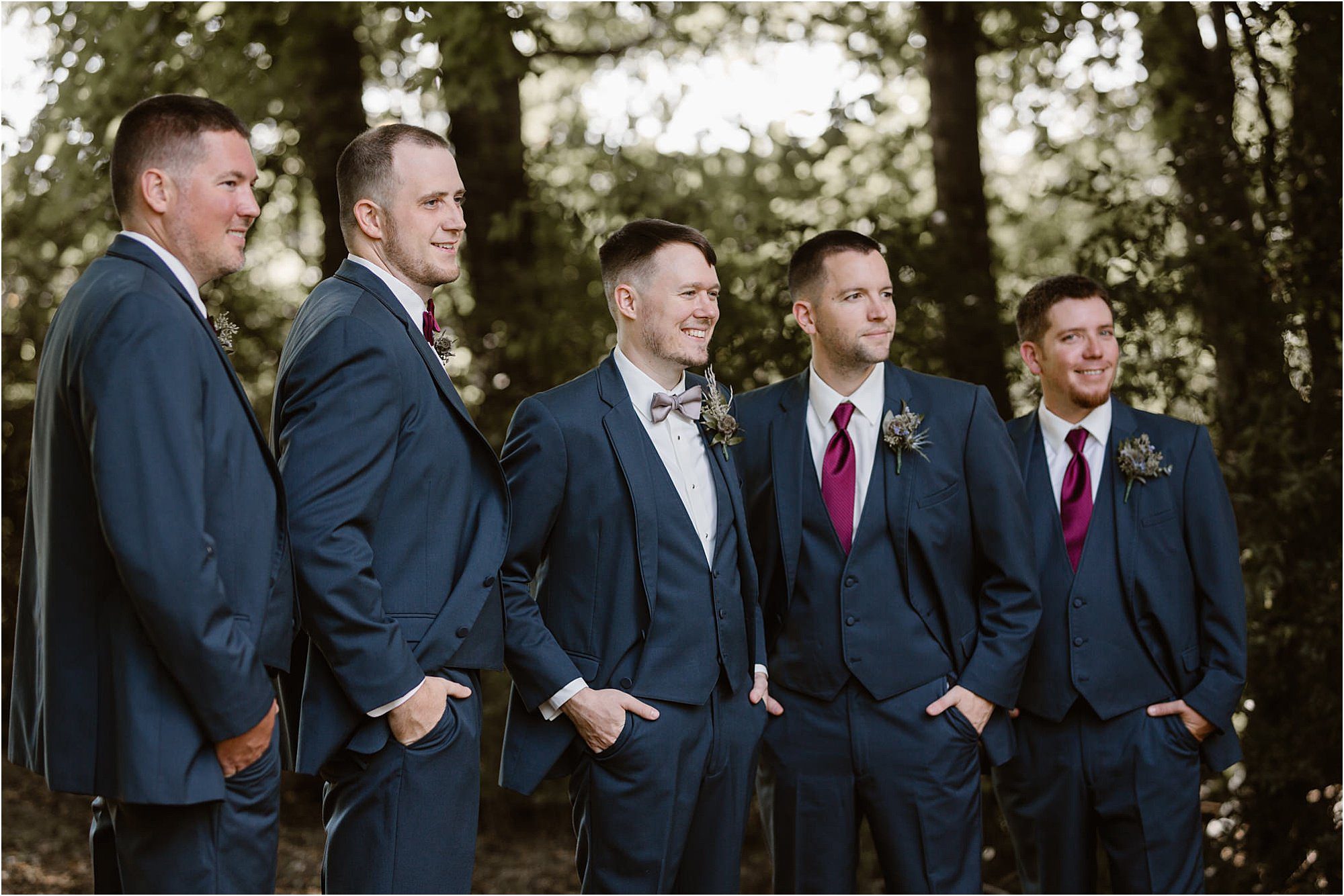 groom and groomsmen standing in blue suits