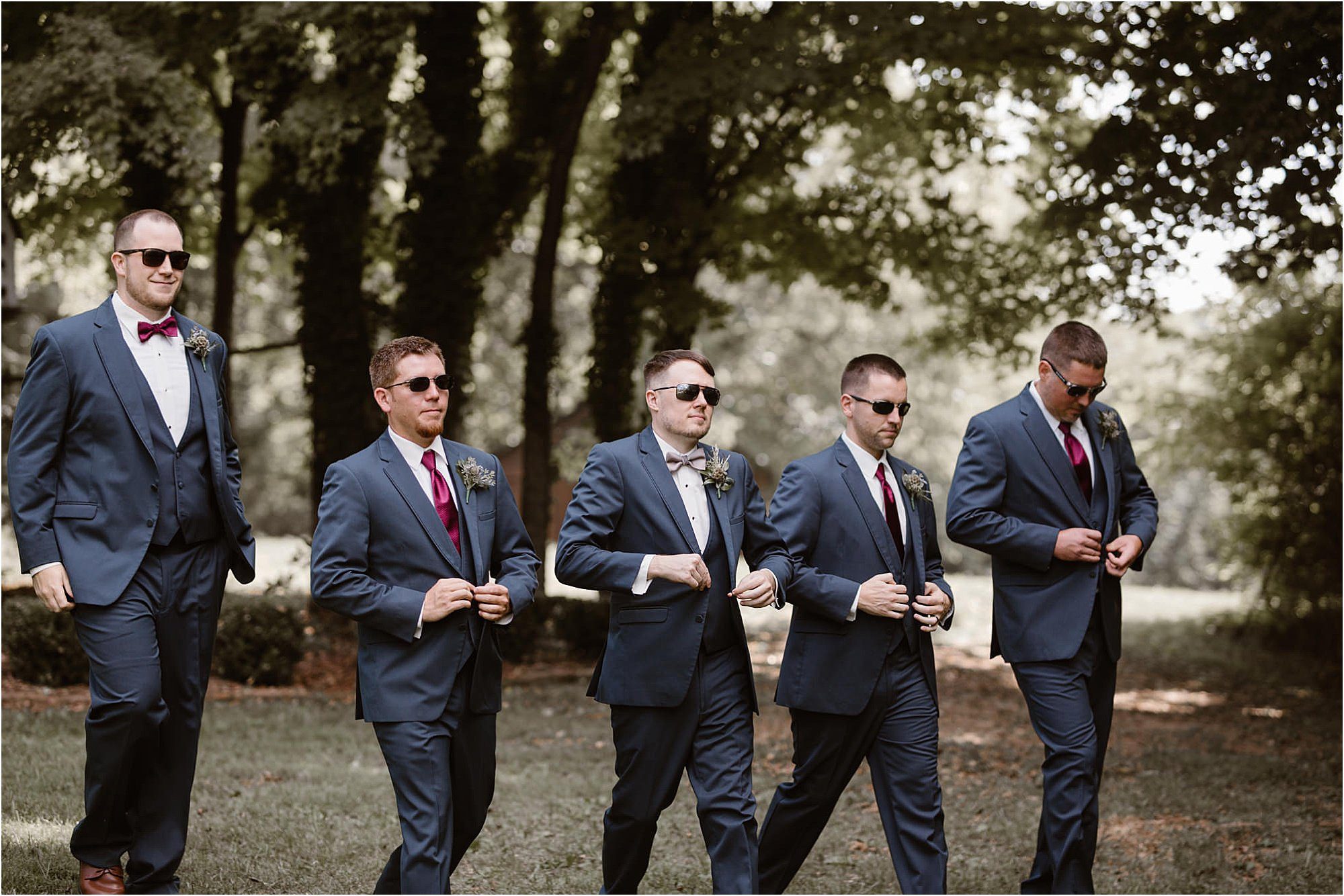 groom and groomsmen wearing blue suits and sunglasses