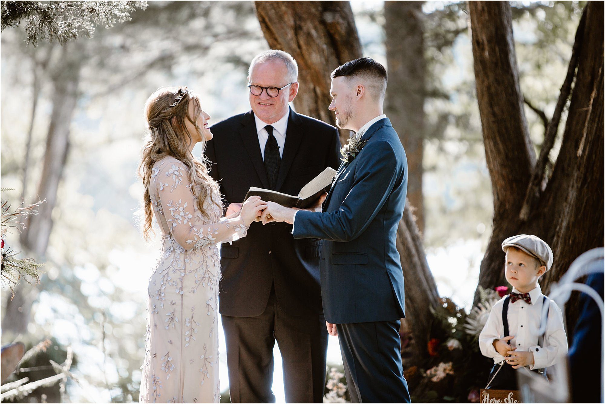 bride and groom exchange rings at jewel-toned wedding