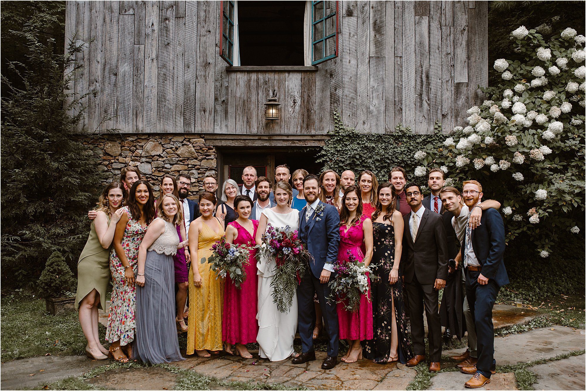 guests and attendants in colorful wedding attire at wildflower wedding
