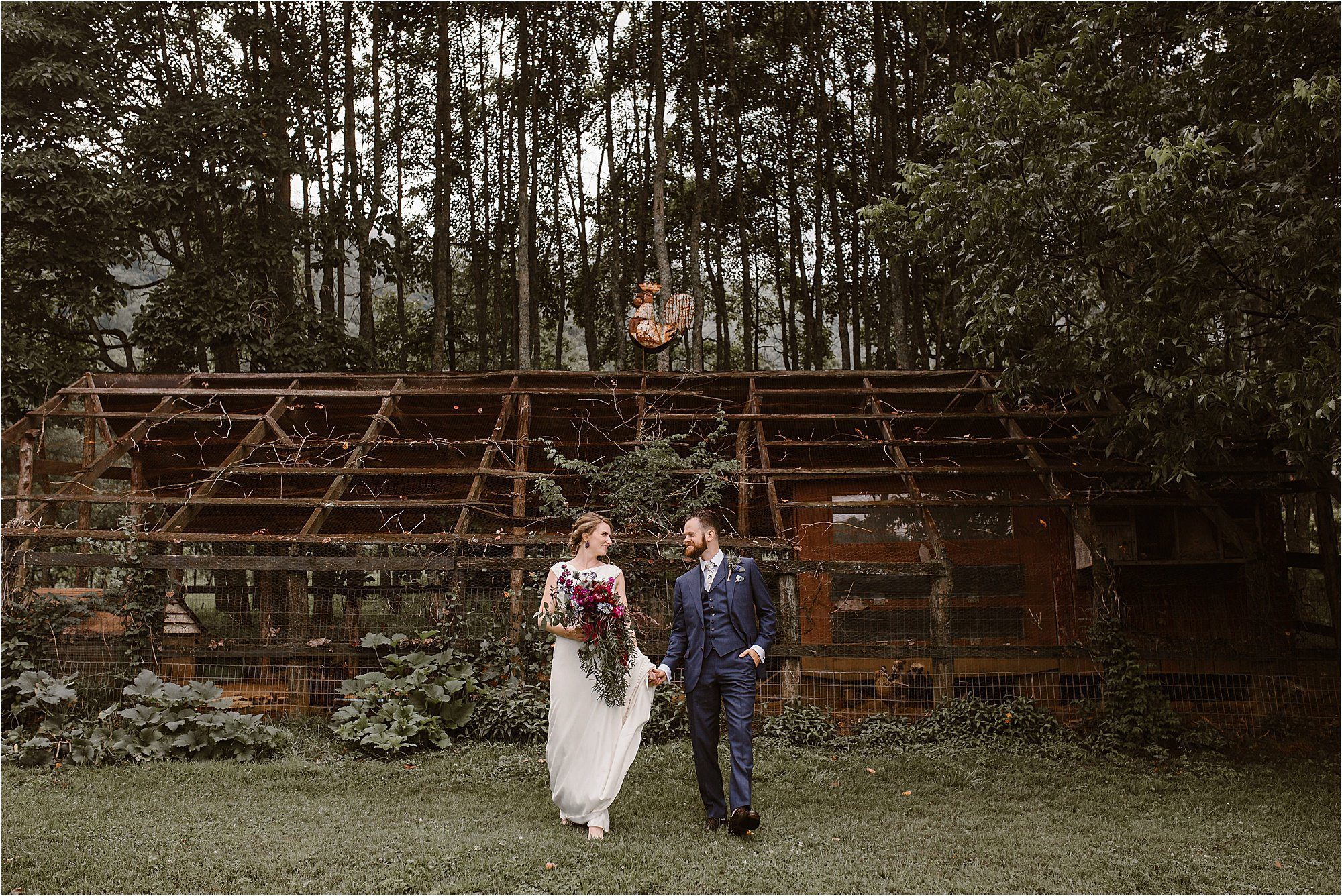 bride and groom walk infront of chicken coop on wedding day