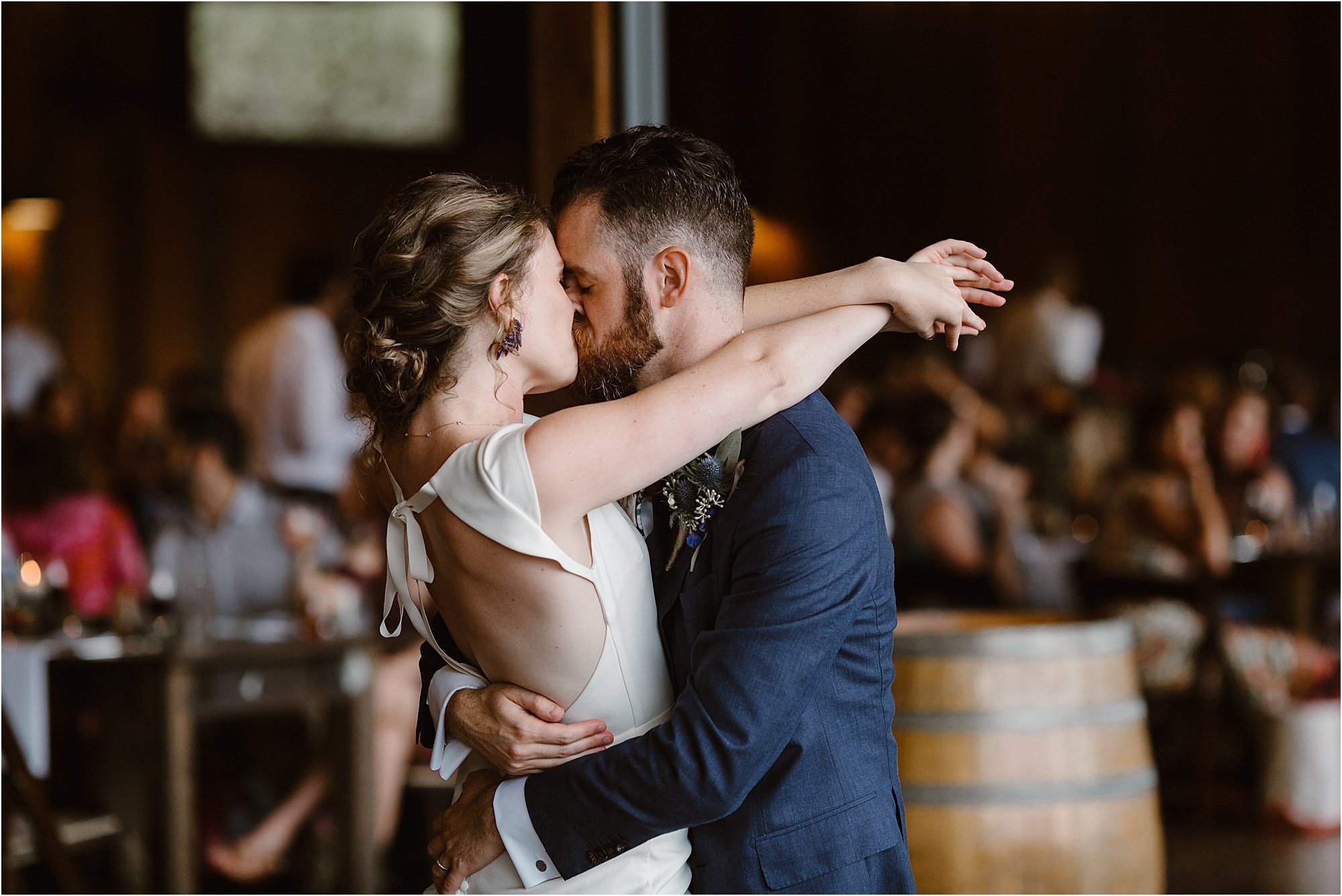 bride and groom kiss while first dance