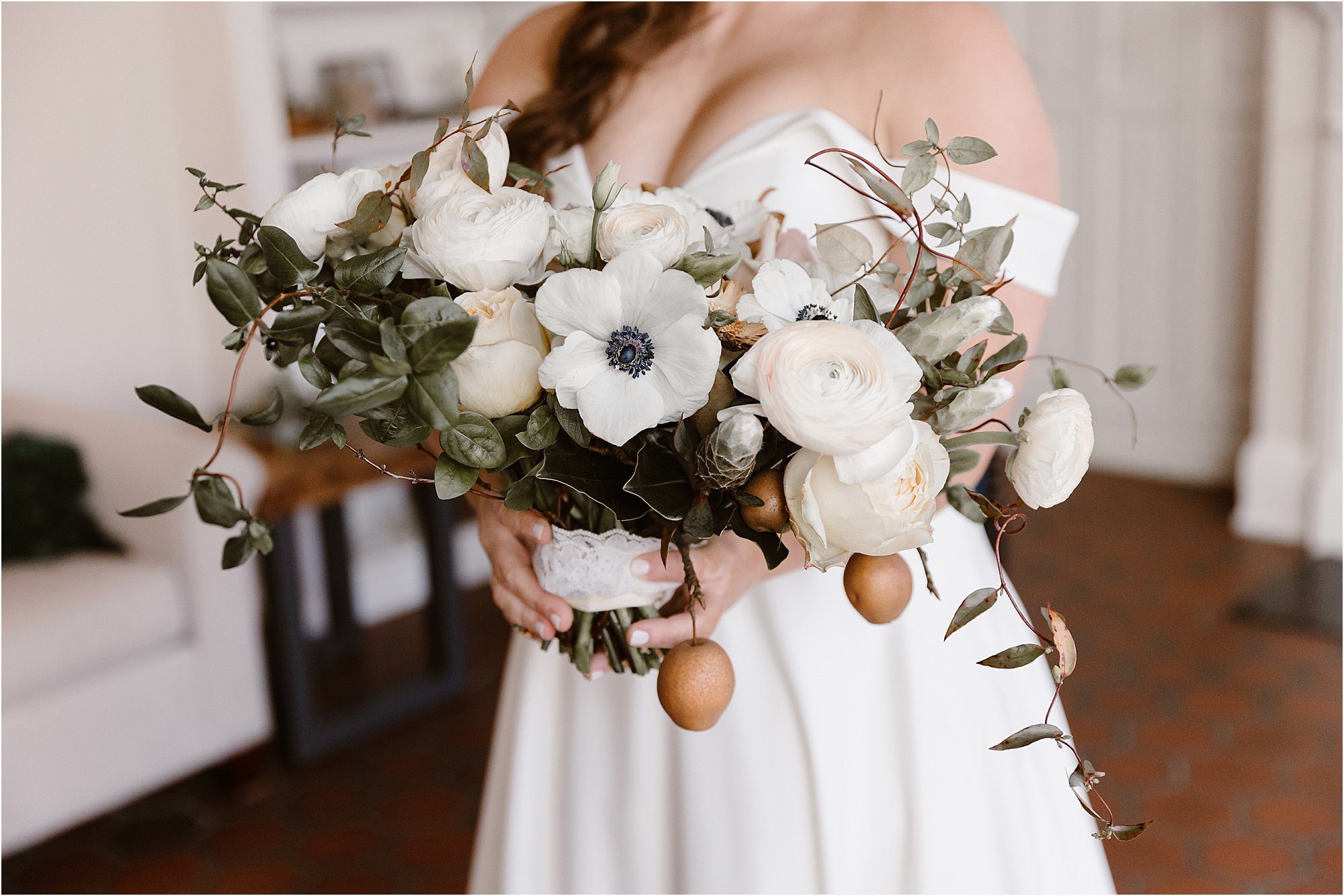 wedding bouquet with white roses and hanging pears with leaves