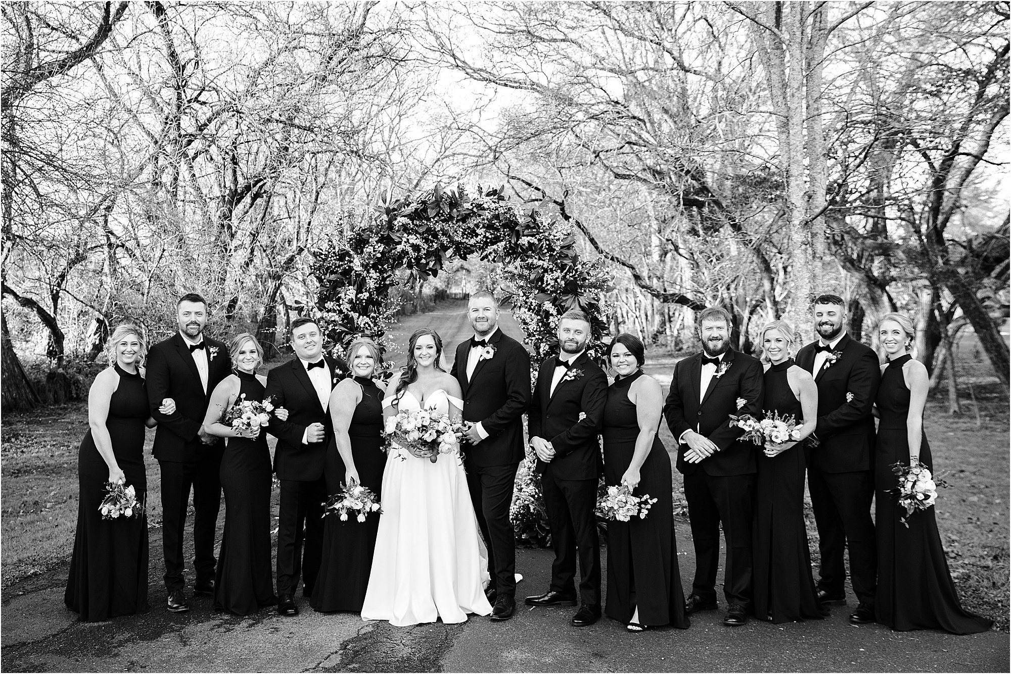 black and white photo of wedding party with bridesmaids and groomsmen