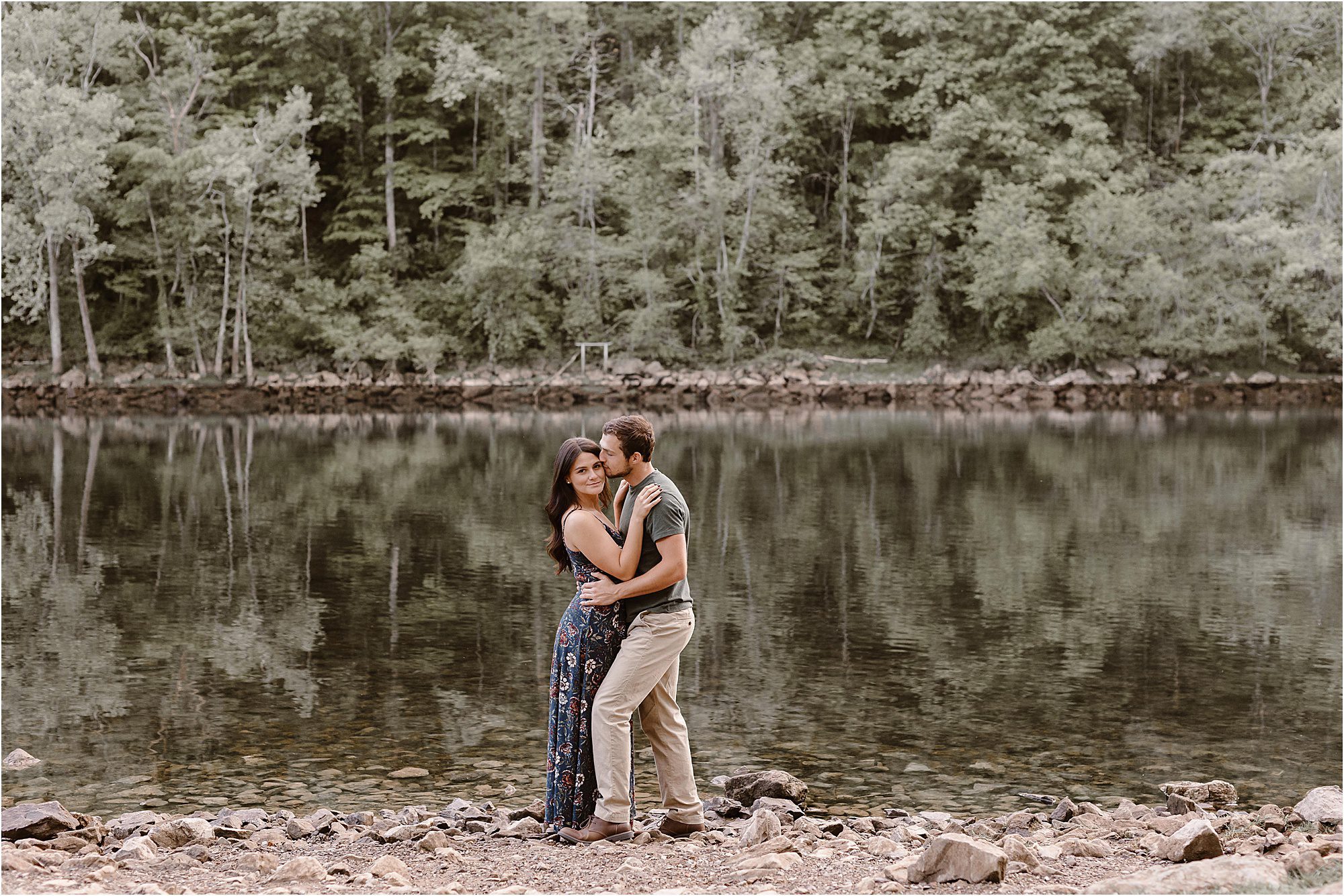man and woman kiss in front of Tennessee River