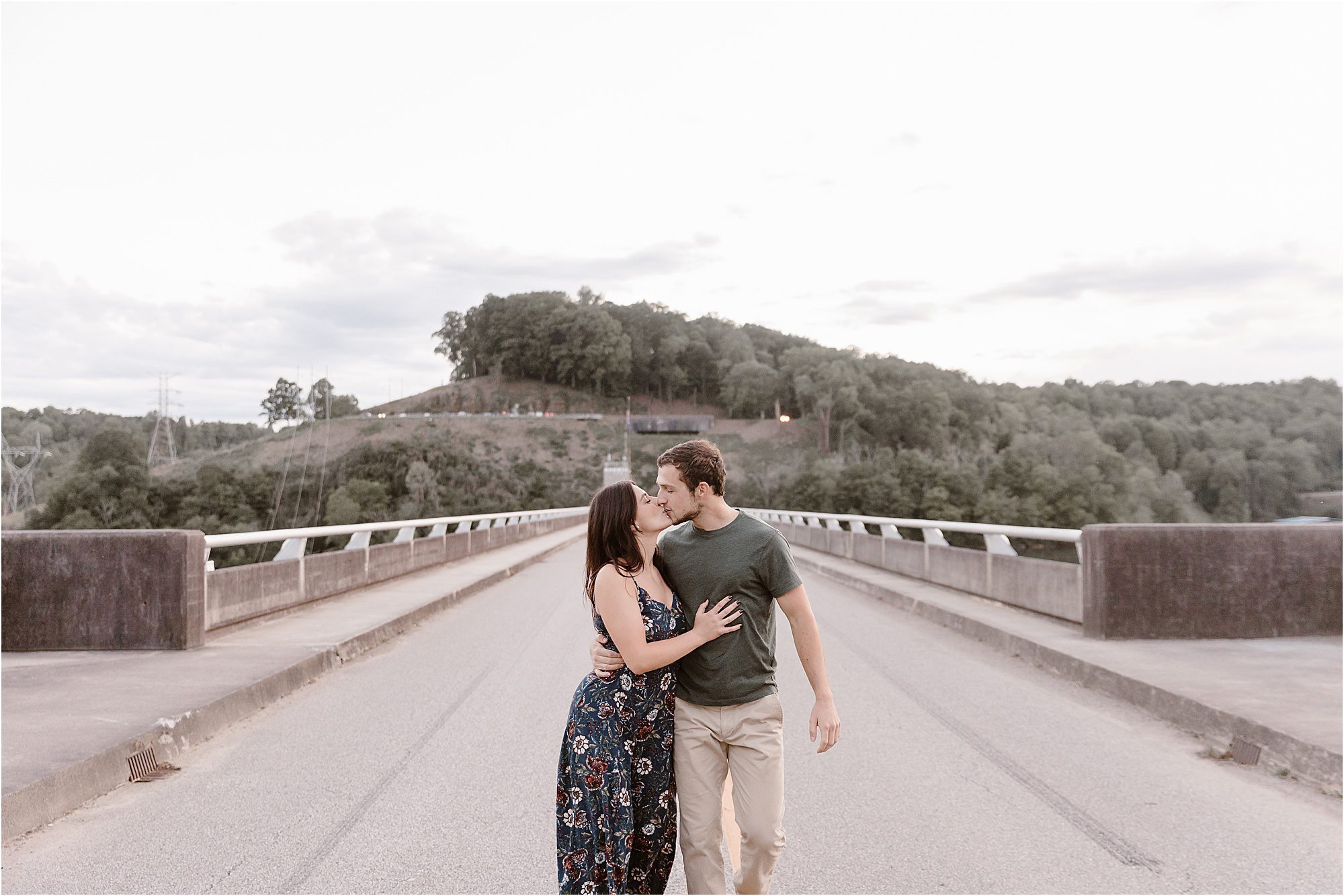 man and woman walk on road at Norris Dam Engagement Session