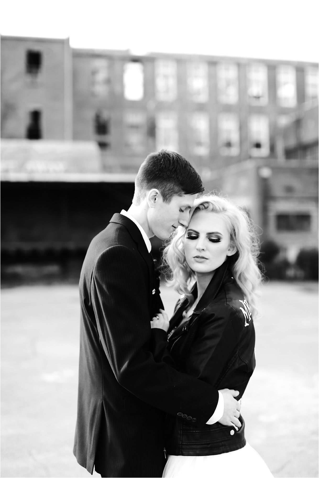black and white photo of a bride and groom in black leather jacket