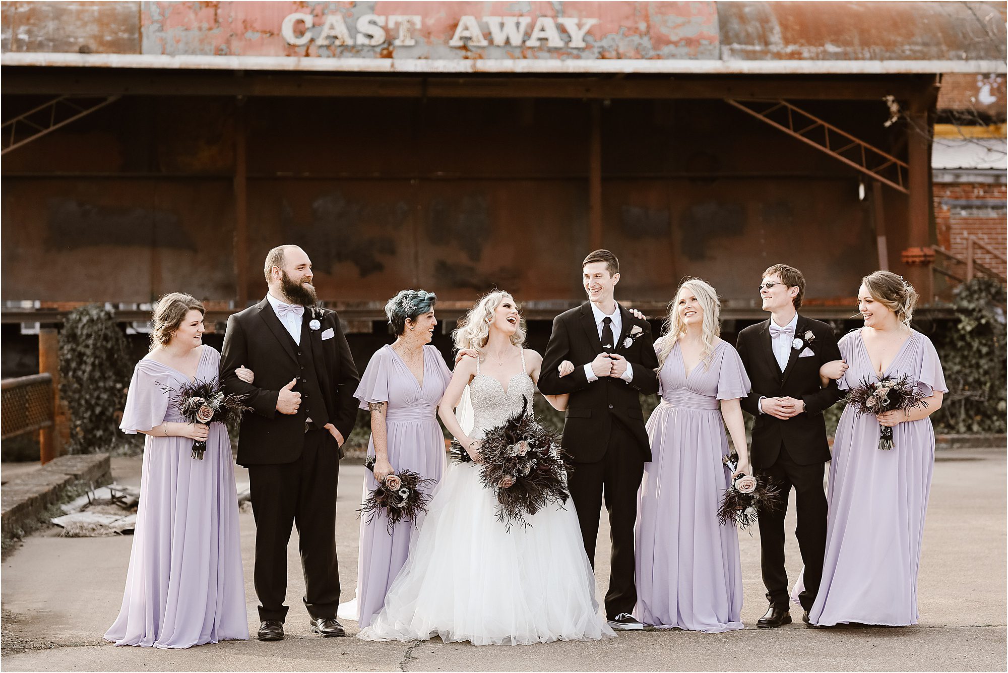 bridal party walking at abandoned warehouse