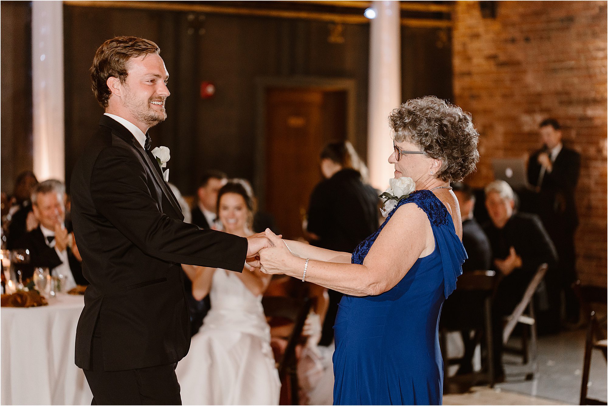 groom and mother dance at wedding ceremony
