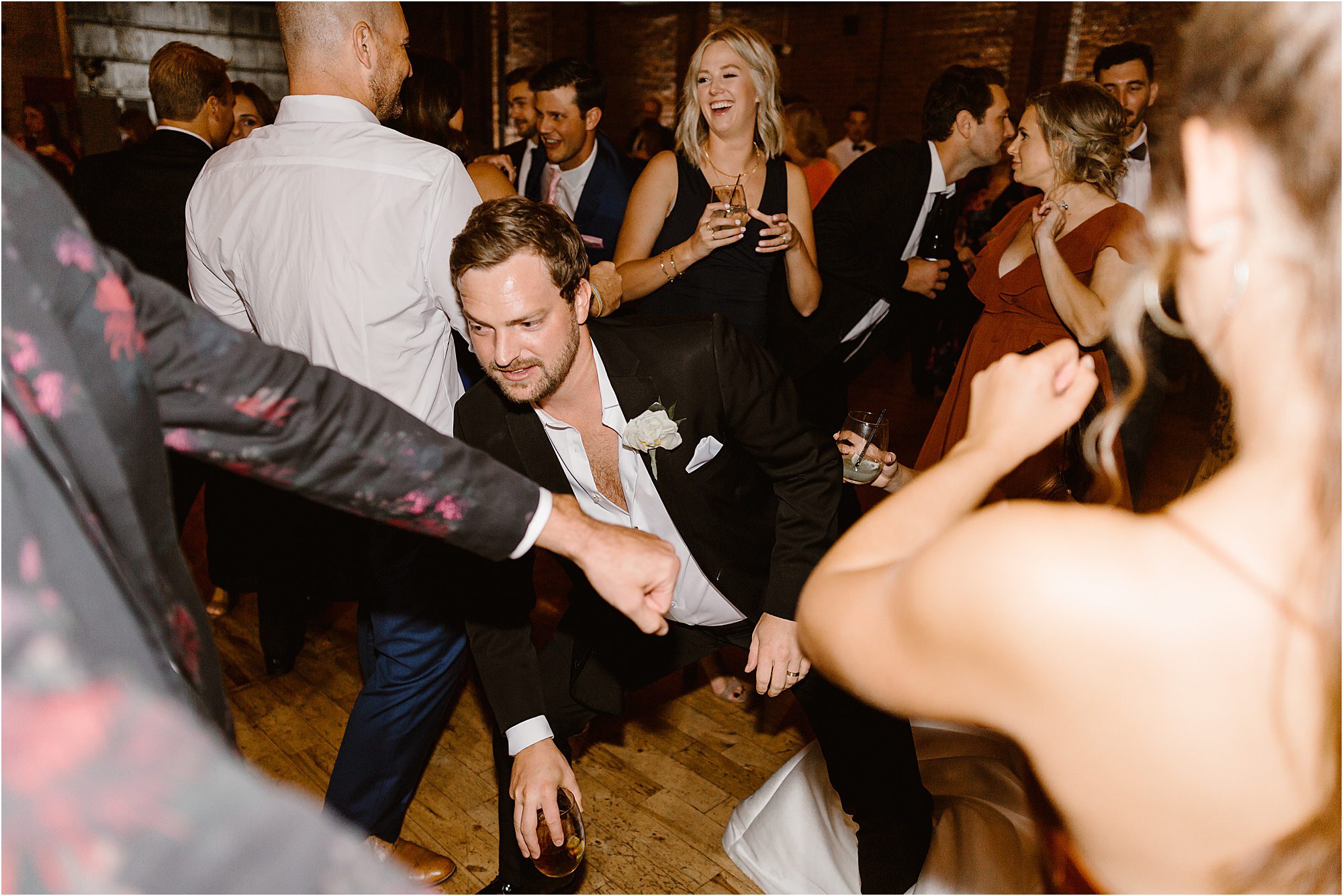 groom dances on the dance floor at the wedding reception