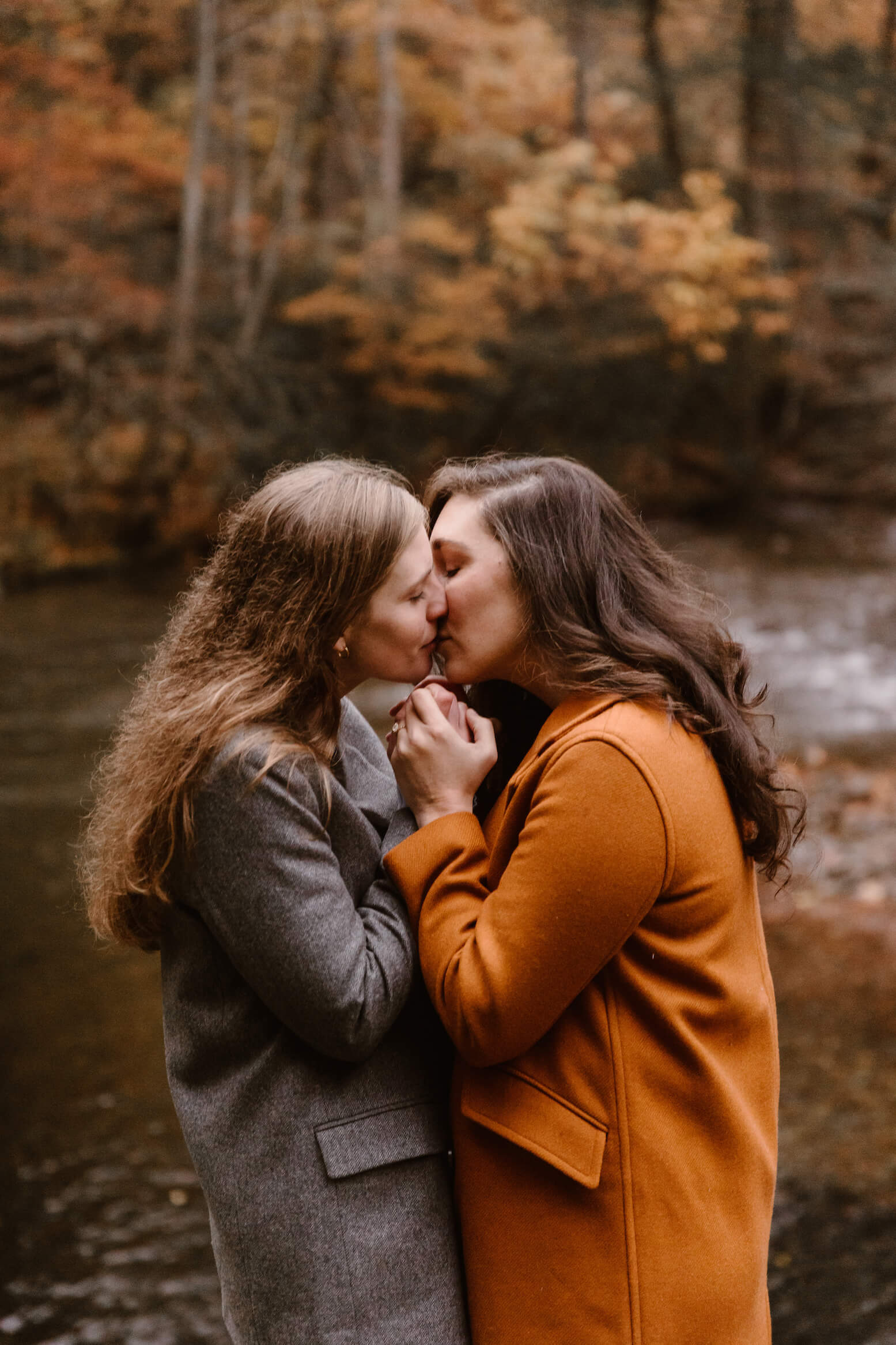 two women kissing and holding hands in the Smokies by Erin Morrison