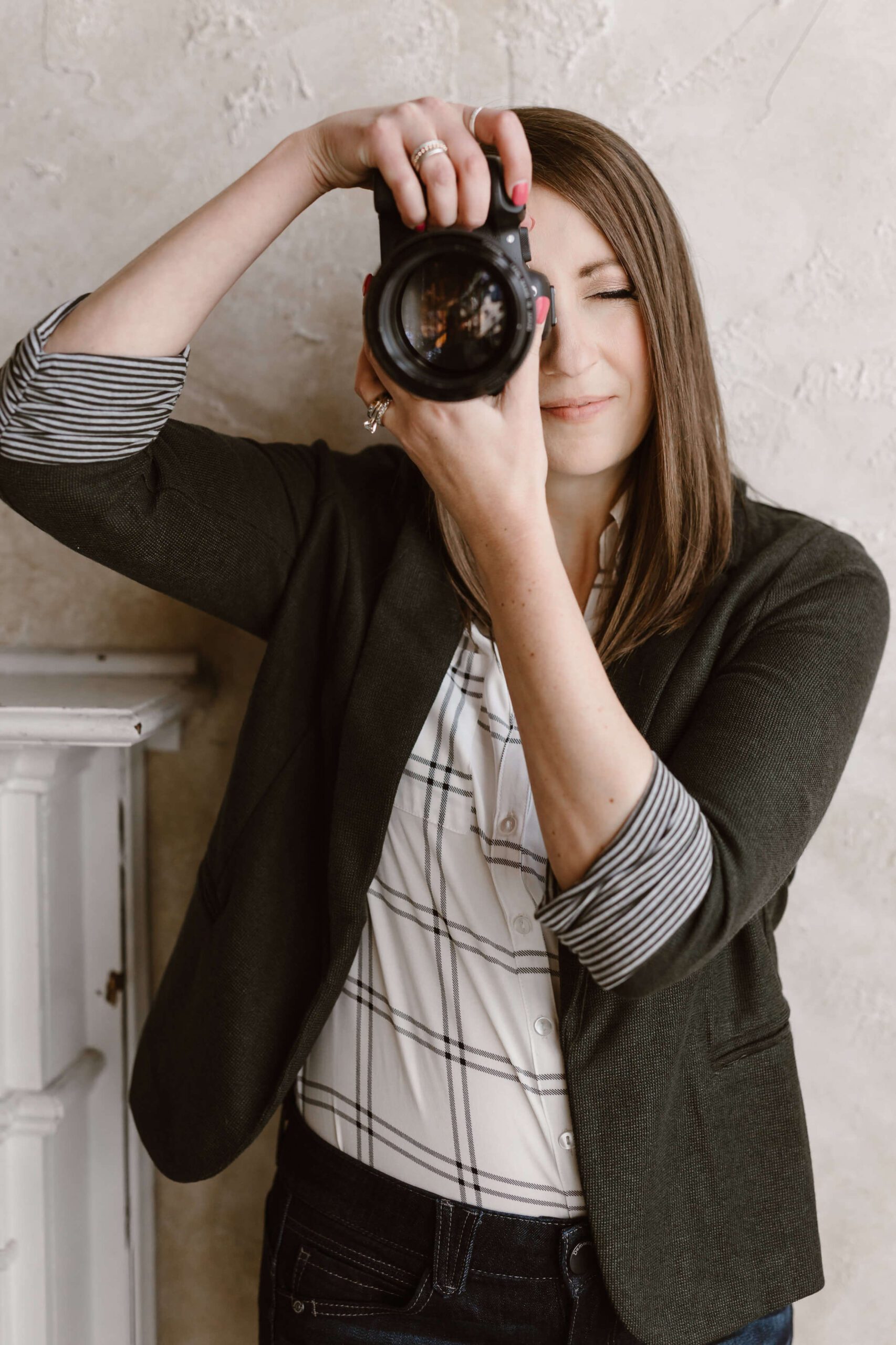 About Erin Morrison Photography holding camera and taking photo