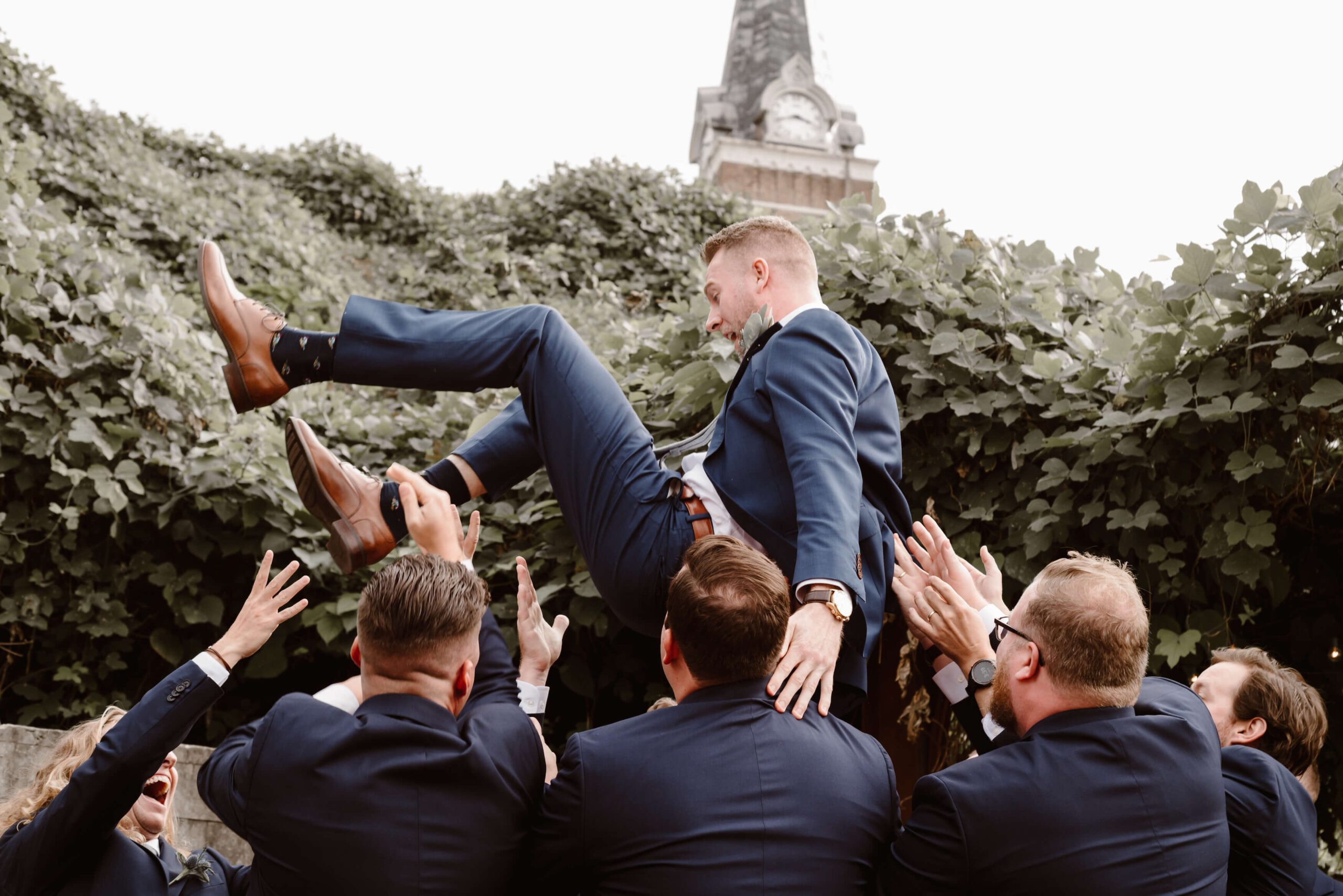 groom being tossed in the air by groomsmen is on the Erin Morrison Blog