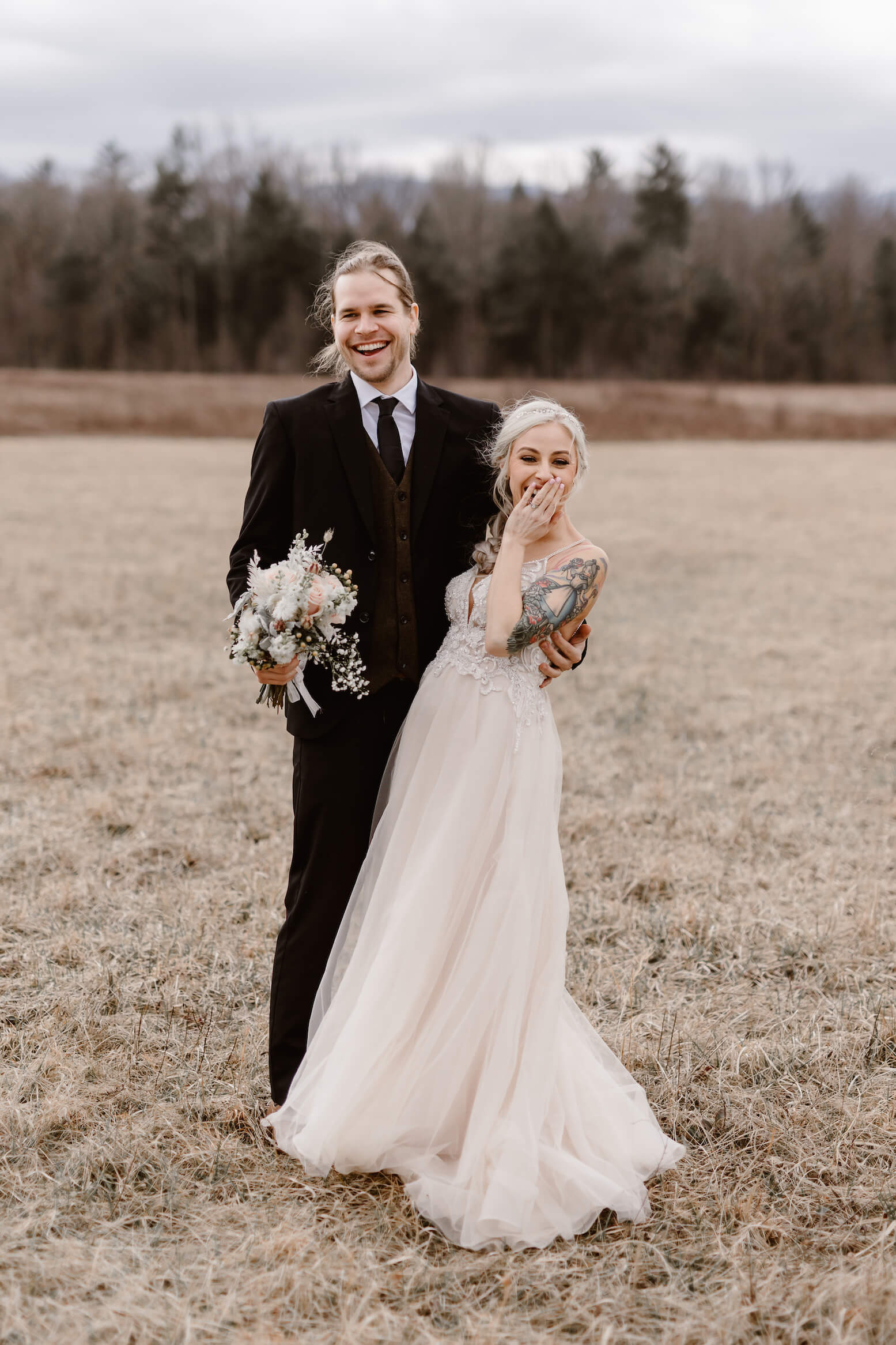 bride and groom laughing in field at Cades Cove Elopement
