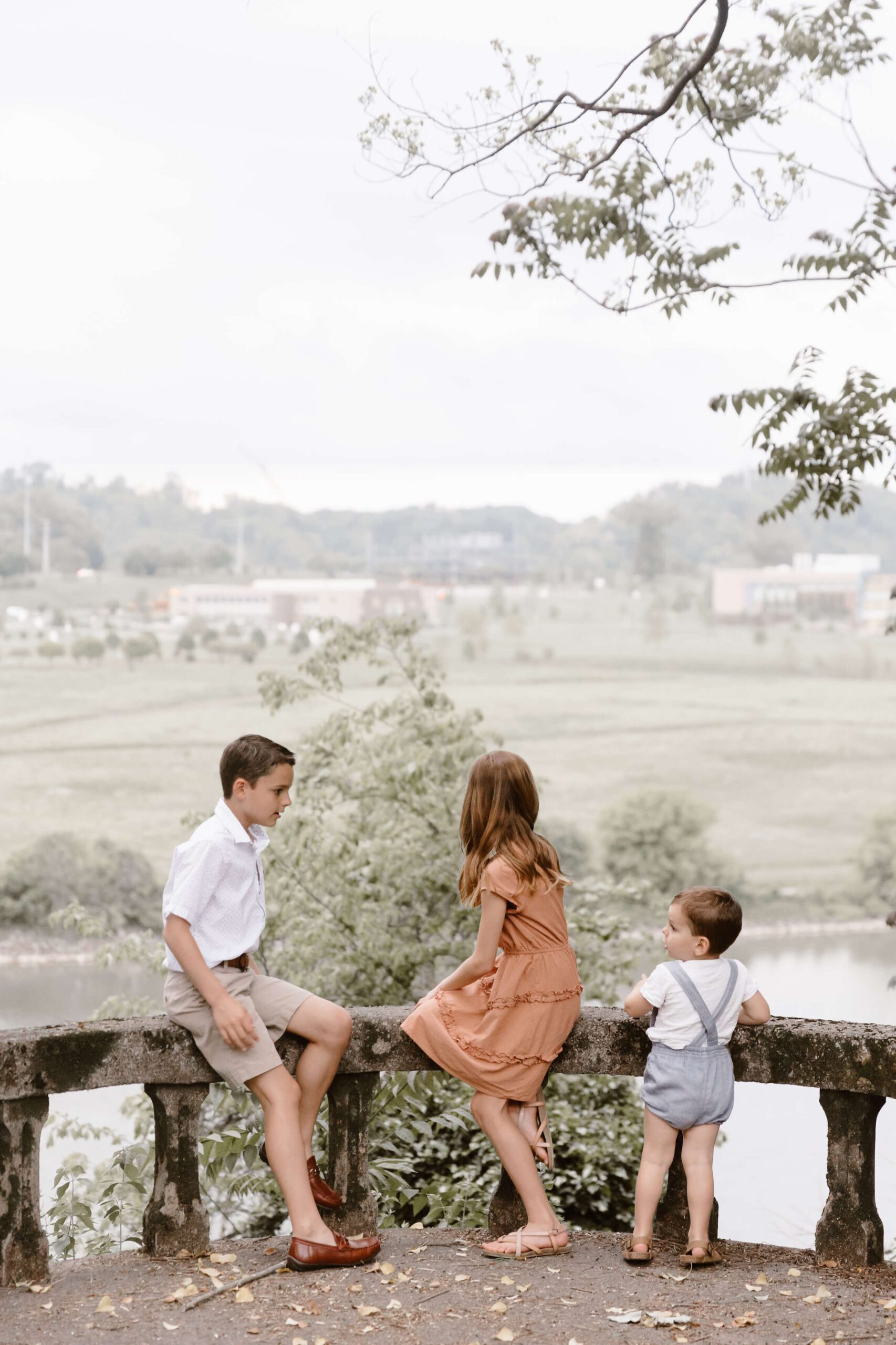 children sitting on overlook at rivers edge at family session by Knoxville Family Photographer Erin Morrison