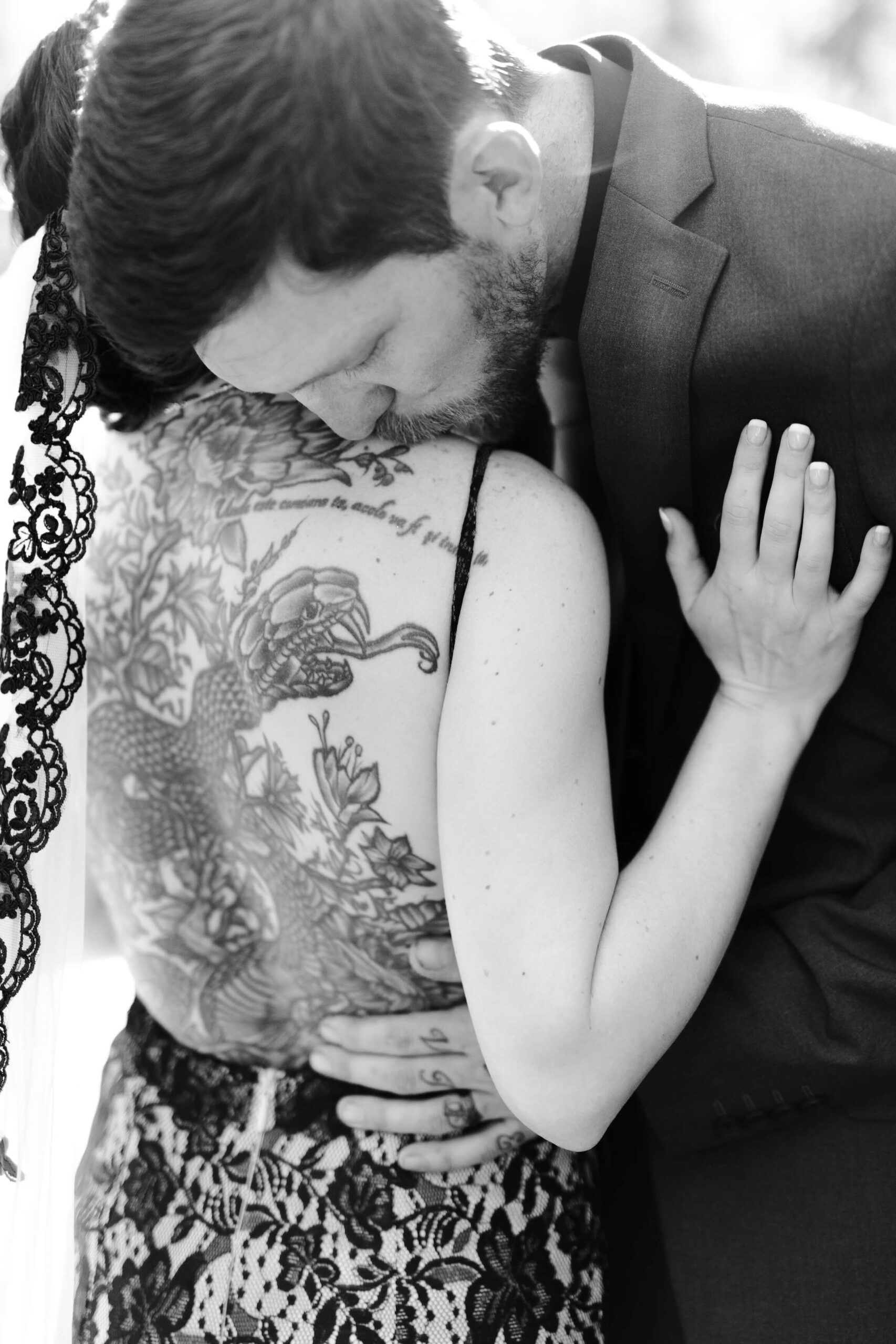groom kissing bride on back while she is wearing black veil photographed by Knoxville Wedding Photographer in Tennessee