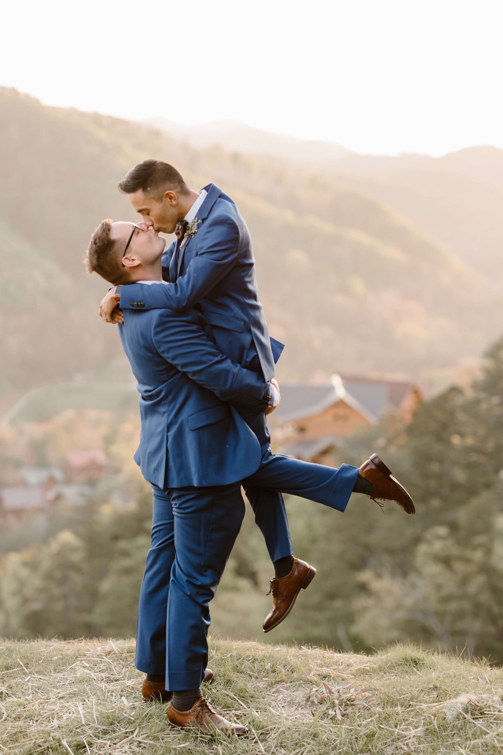 men in blue suits kissing at LGBT wedding photographed by Erin Morrison
