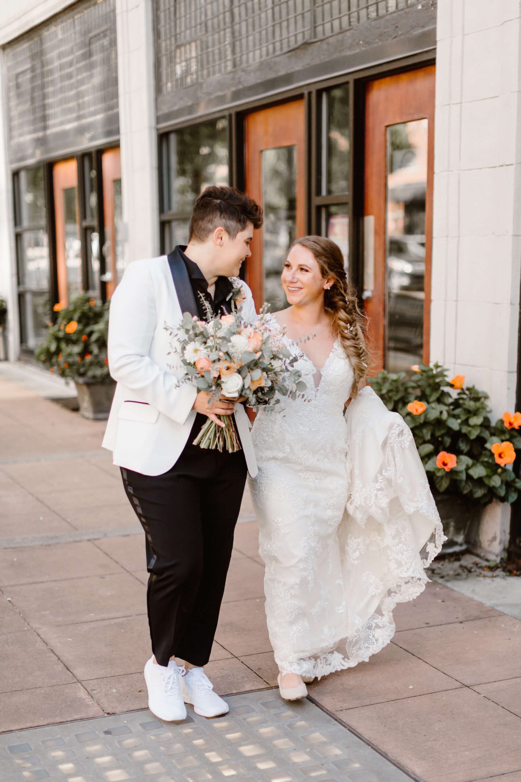 two women walking in downtown Knoxville at wedding photographed by Knoxville wedding photographer Erin Morrison