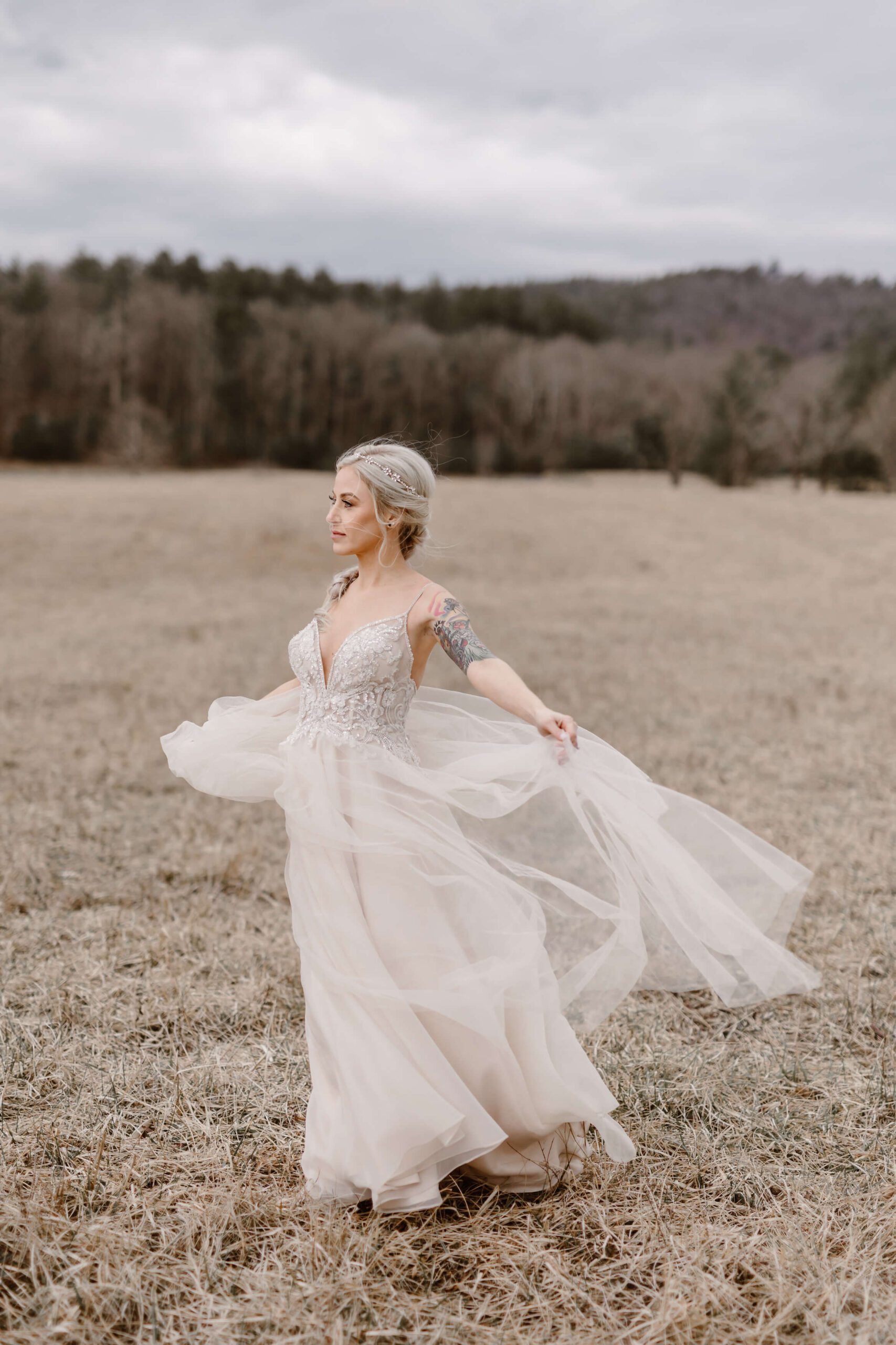 woman in flowing wedding dress walking through field in the Smoky Mountains photographed by Smoky Mountain Photographer Erin Morrison