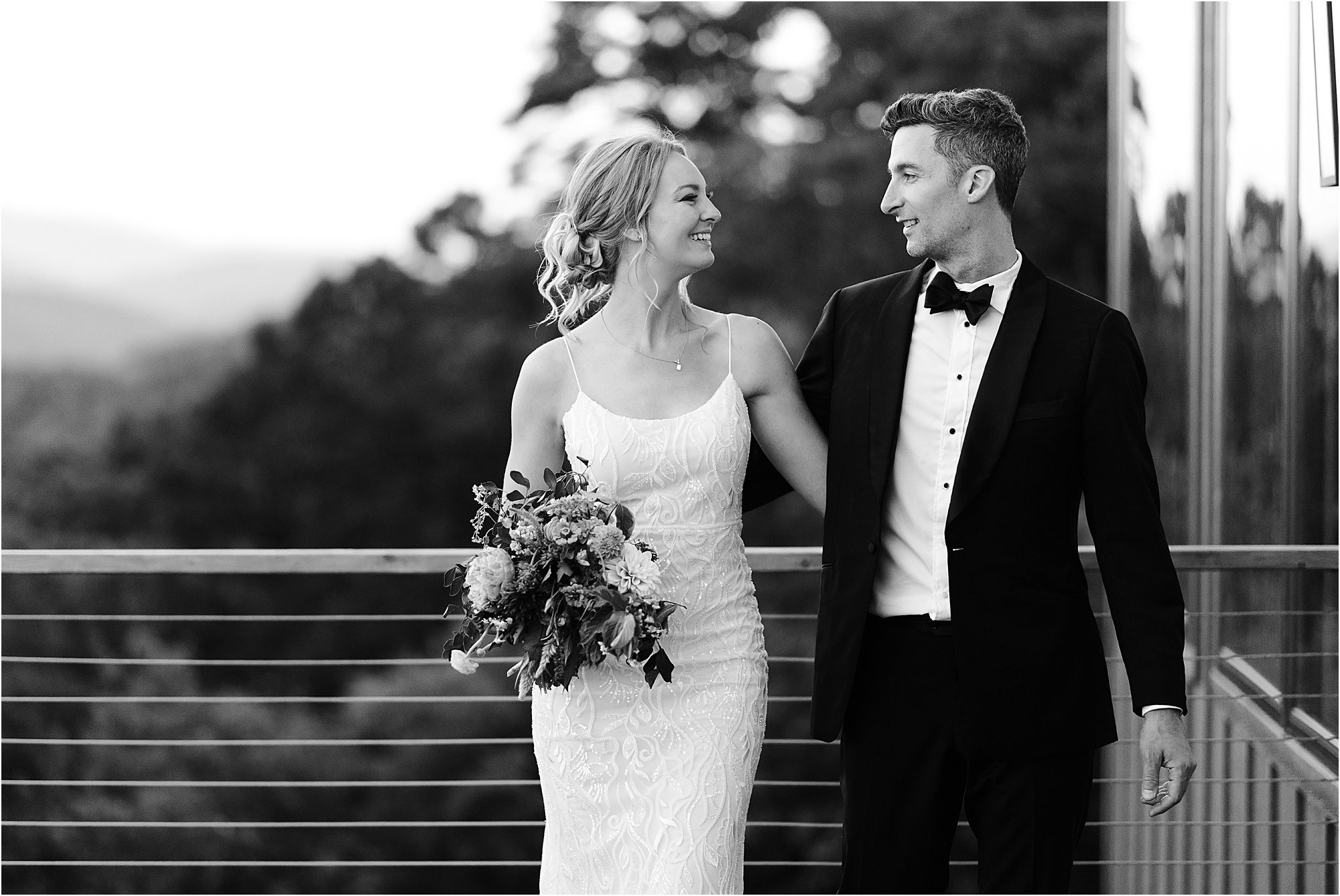 black and white photo of bride and groom on patio of wedding venue