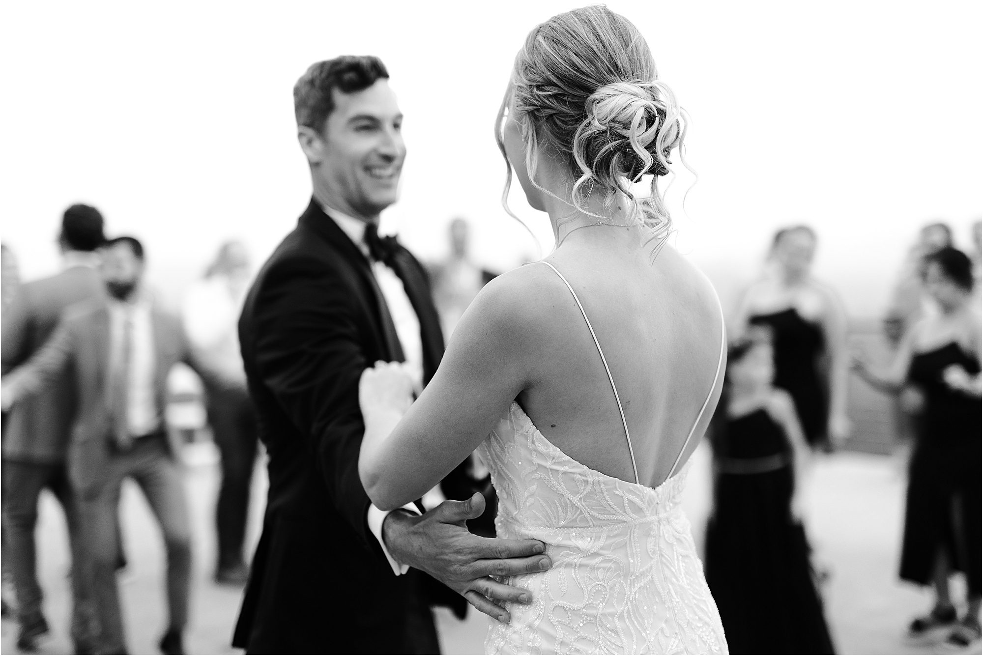 black and white dancing photo of bride and groom