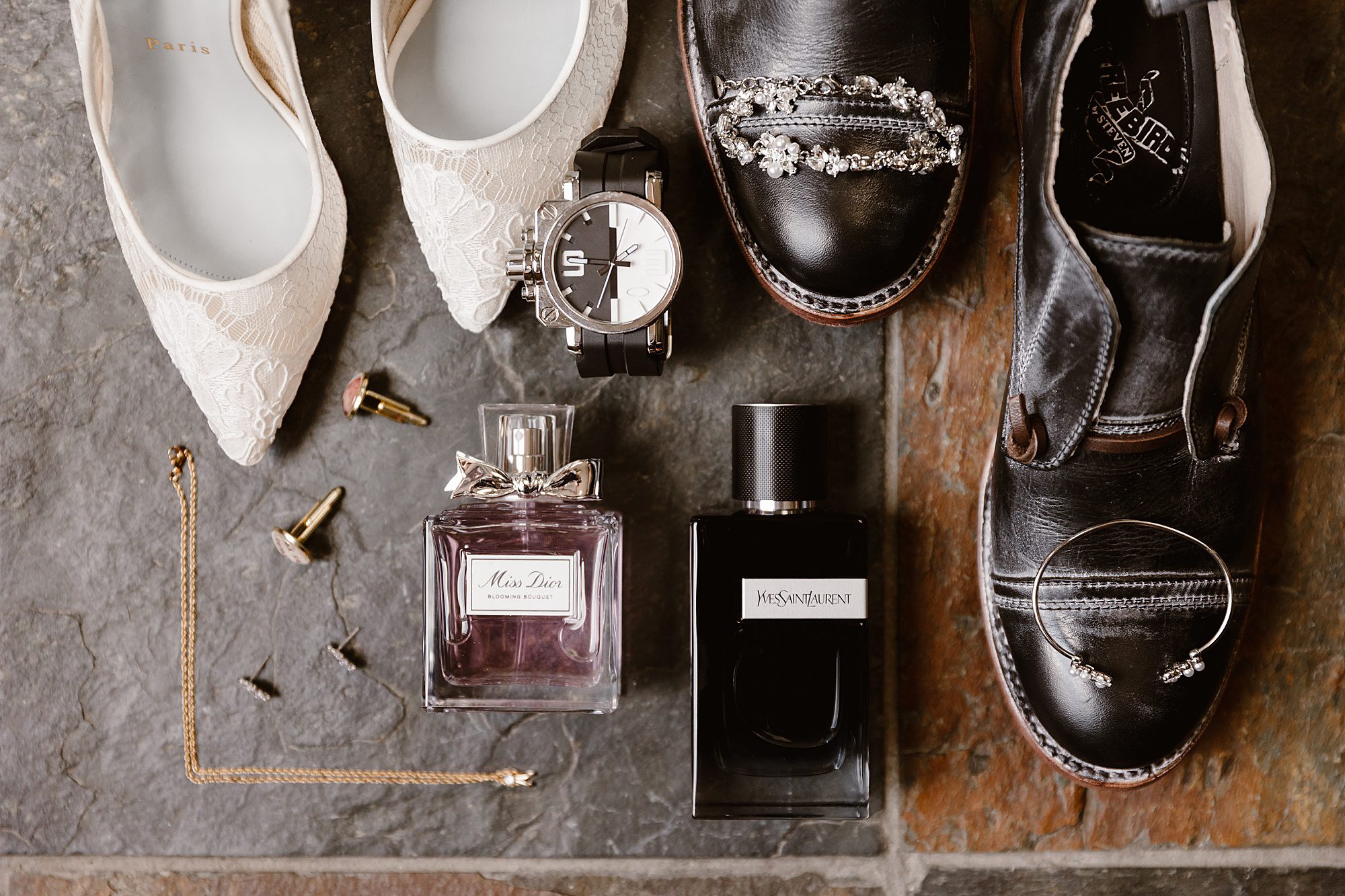 wedding details with cologne, perfume, shoes, and watches