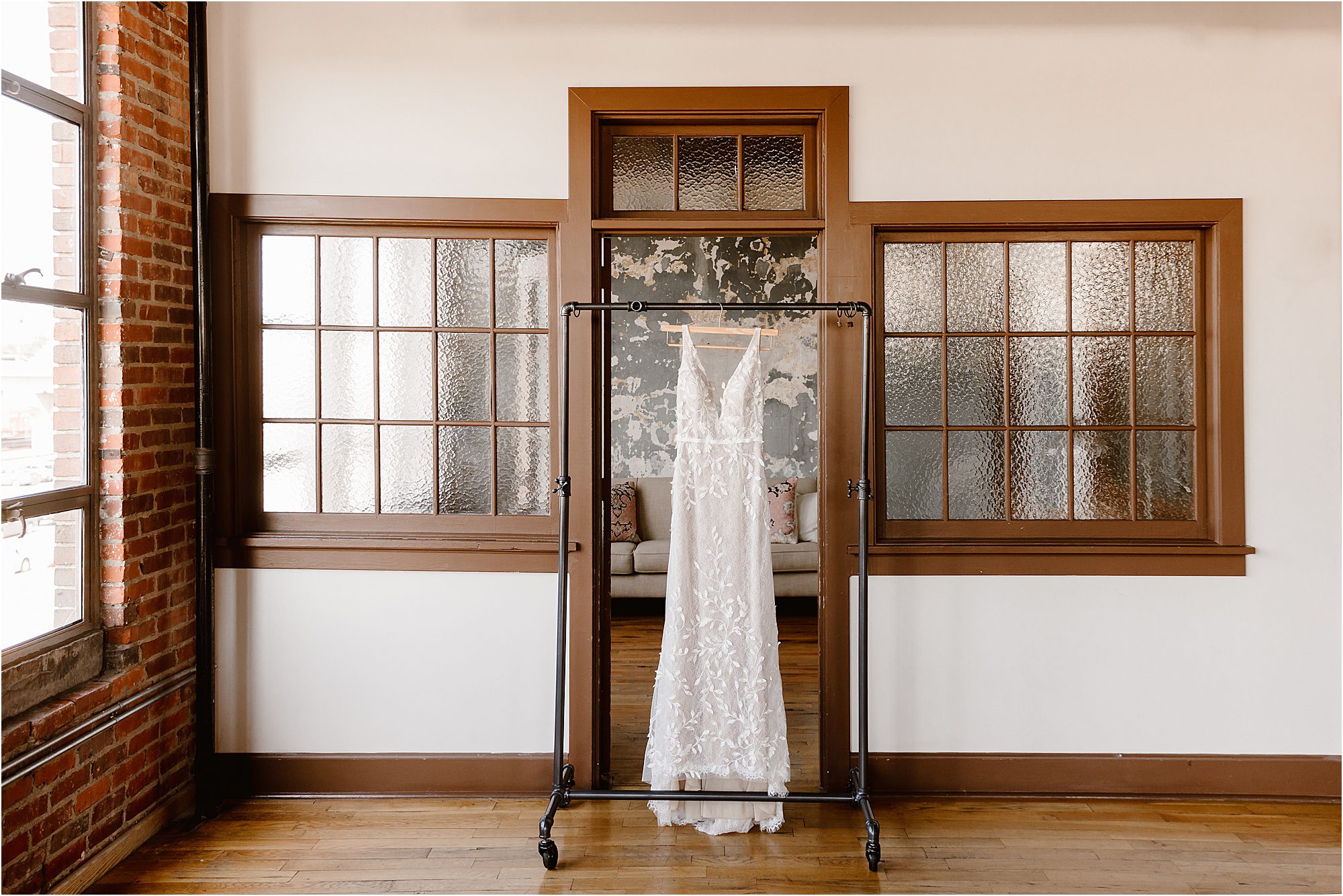 white wedding dress hanging on rolling dress rack
