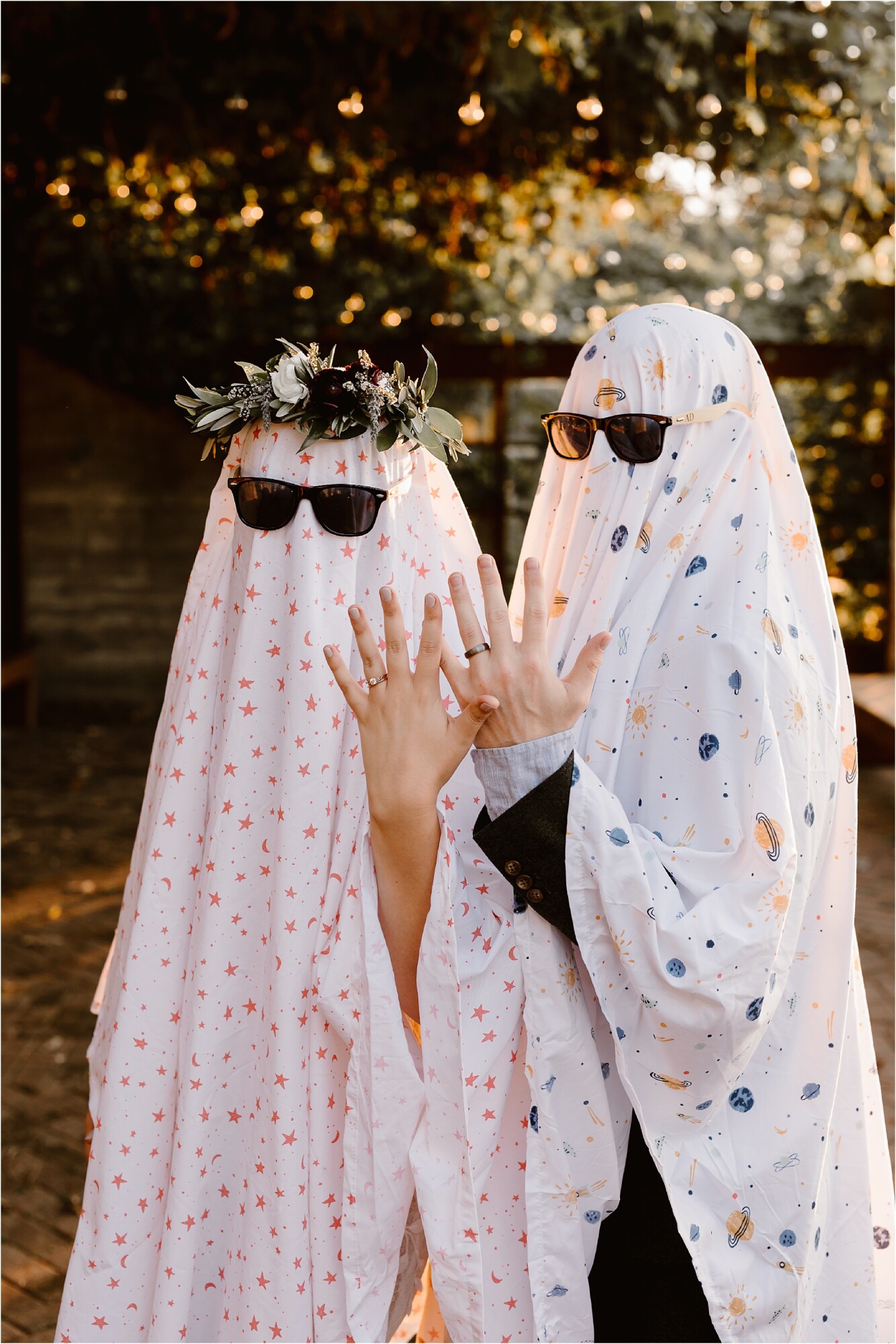 man and woman where bed sheet with flower crown and sunglasses for Ghost Sheet Trend on wedding day