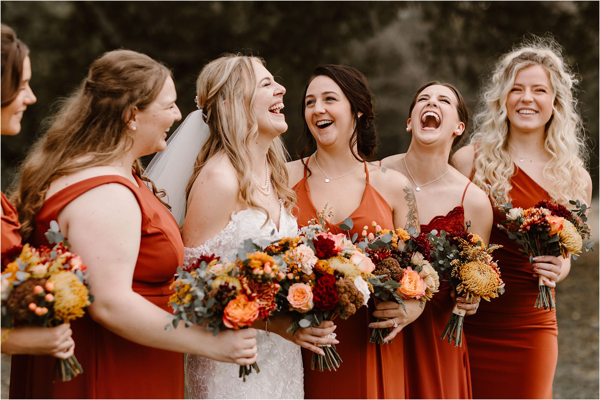 bride laughing with friends at wedding