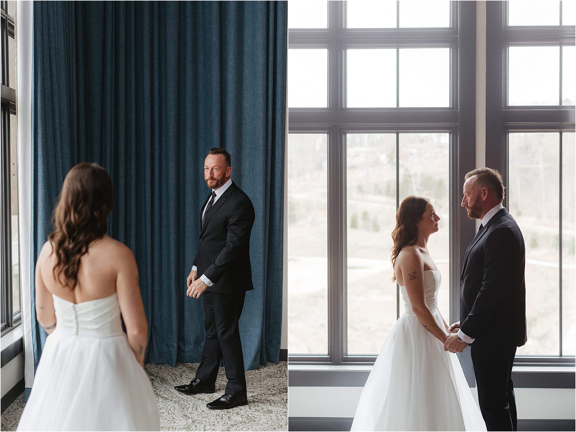 A bride in a white dress and a groom in a black suit share a first look, smiling and holding hands in a bright room with large windows and blue curtains during their wedding at Cloudland at McLemore Resort.