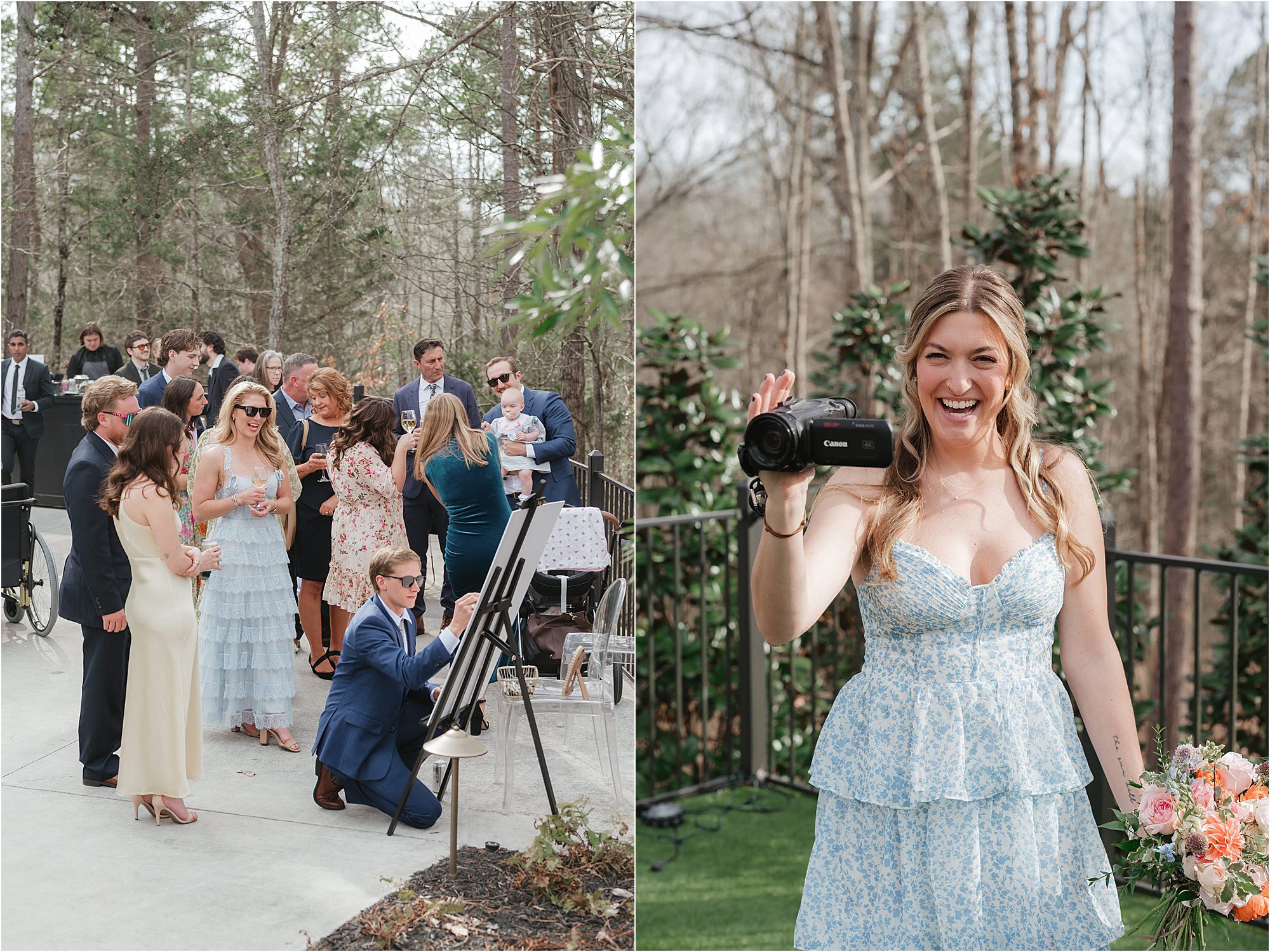 A group of people, dressed formally, gather outdoors near trees; one man kneels to sign a board. On the right, a smiling woman in a blue floral dress holds a video camera, standing on grass with trees in the background—capturing one of those Wedding Ideas That Keep Guests Engaged.